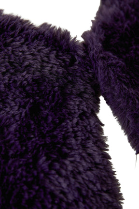 Women's close-up detail of dark purple faux fur texture and open edge on the sleeveless vest by Oui
