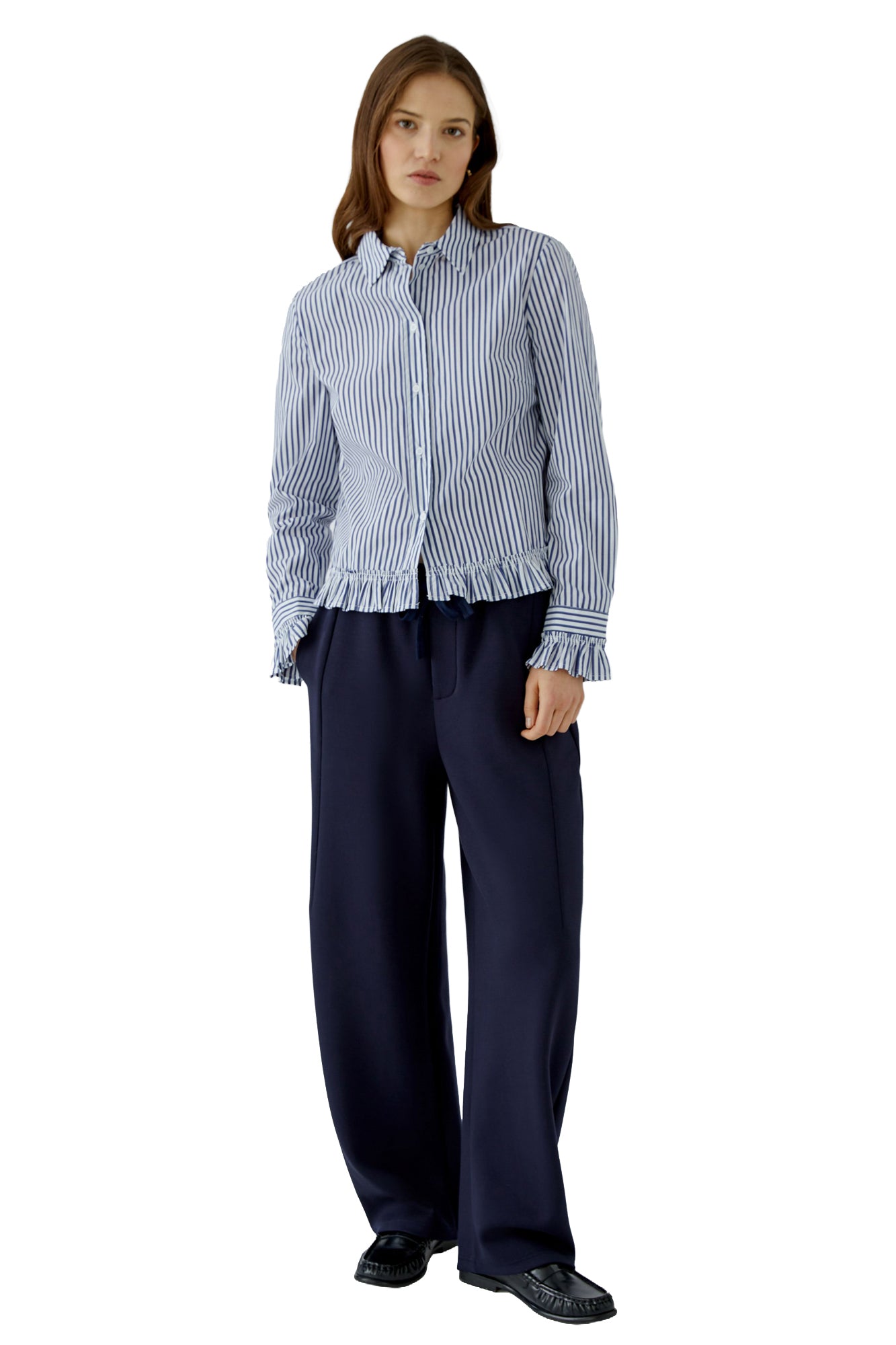 Women's full front model view of blue and white striped long-sleeve blouse with collar, buttons, and ruffle hem by Oui
