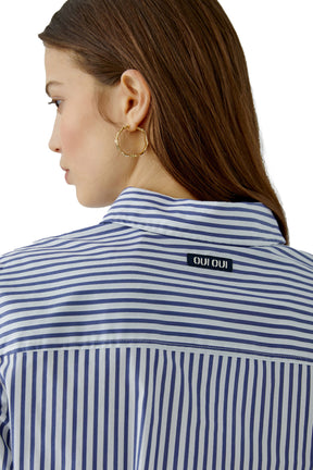 Women's close back neck view of blue and white striped long-sleeve blouse with small black OUI OUI label