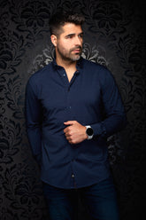 Men's navy long sleeve button-up shirt with small orange dot pattern, shown from the front on model by Au Noir