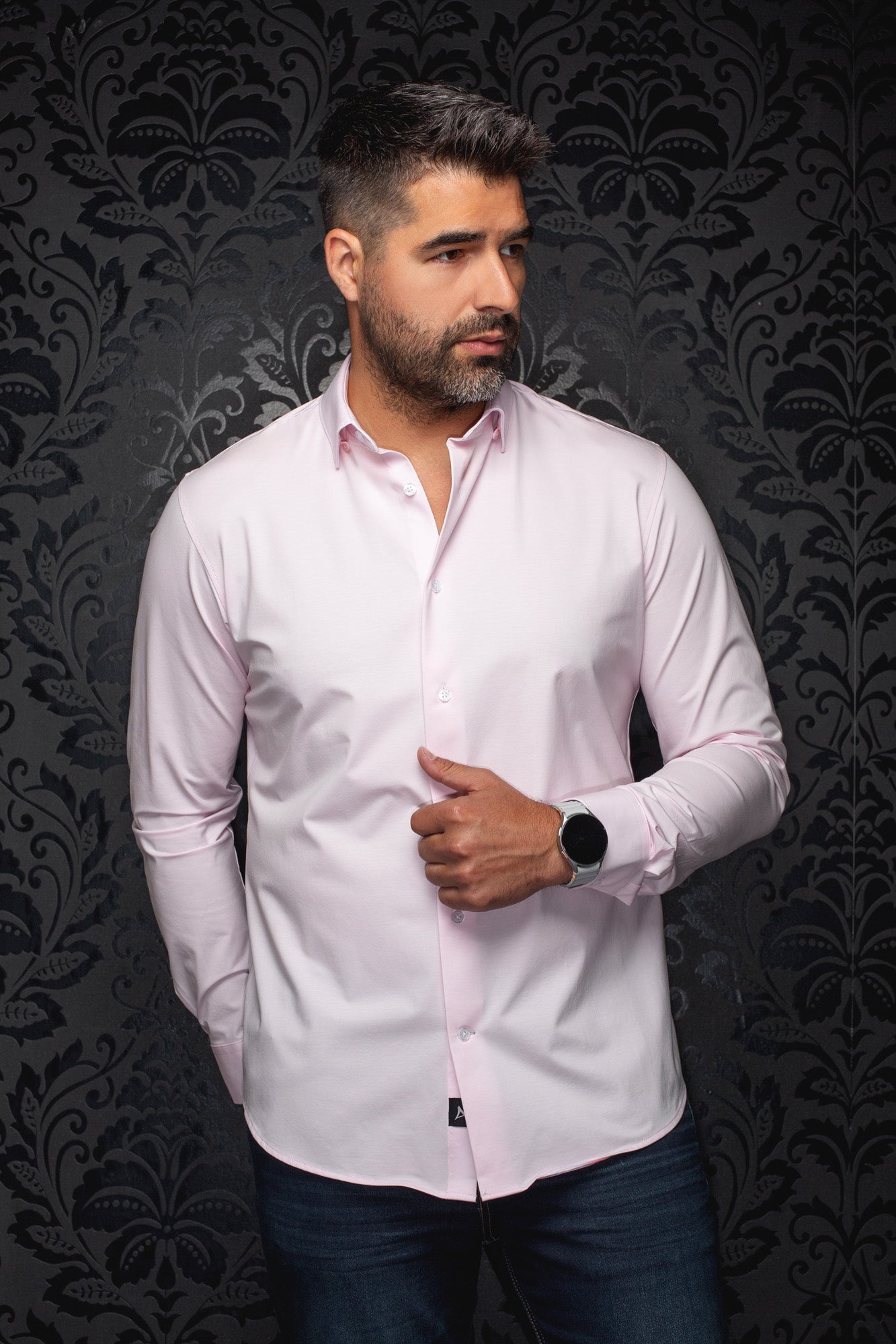 Au Noir men's light pink long sleeve button-up shirt with white buttons and curved hem on model, front view