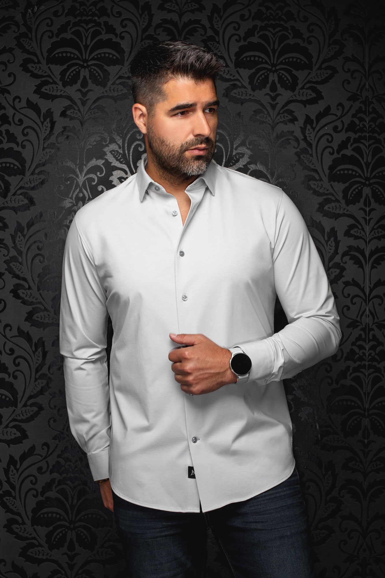 Au Noir men's light gray long sleeve button-up shirt on model showing curved hem, gray buttons and spread collar, front view