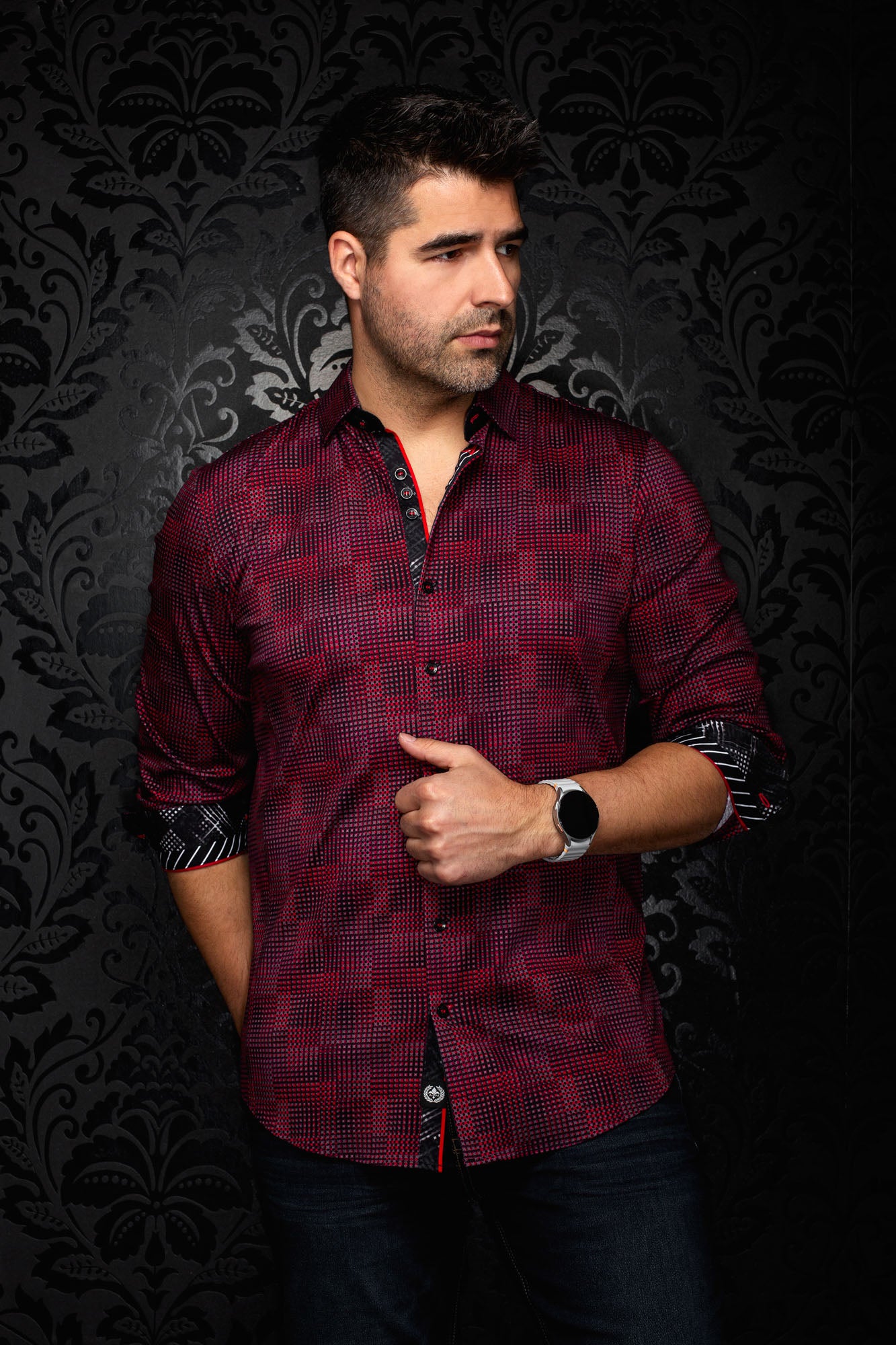 Men's front angled view of a red and black micro-check button-up shirt with rolled contrast cuffs, side view by Au Noir