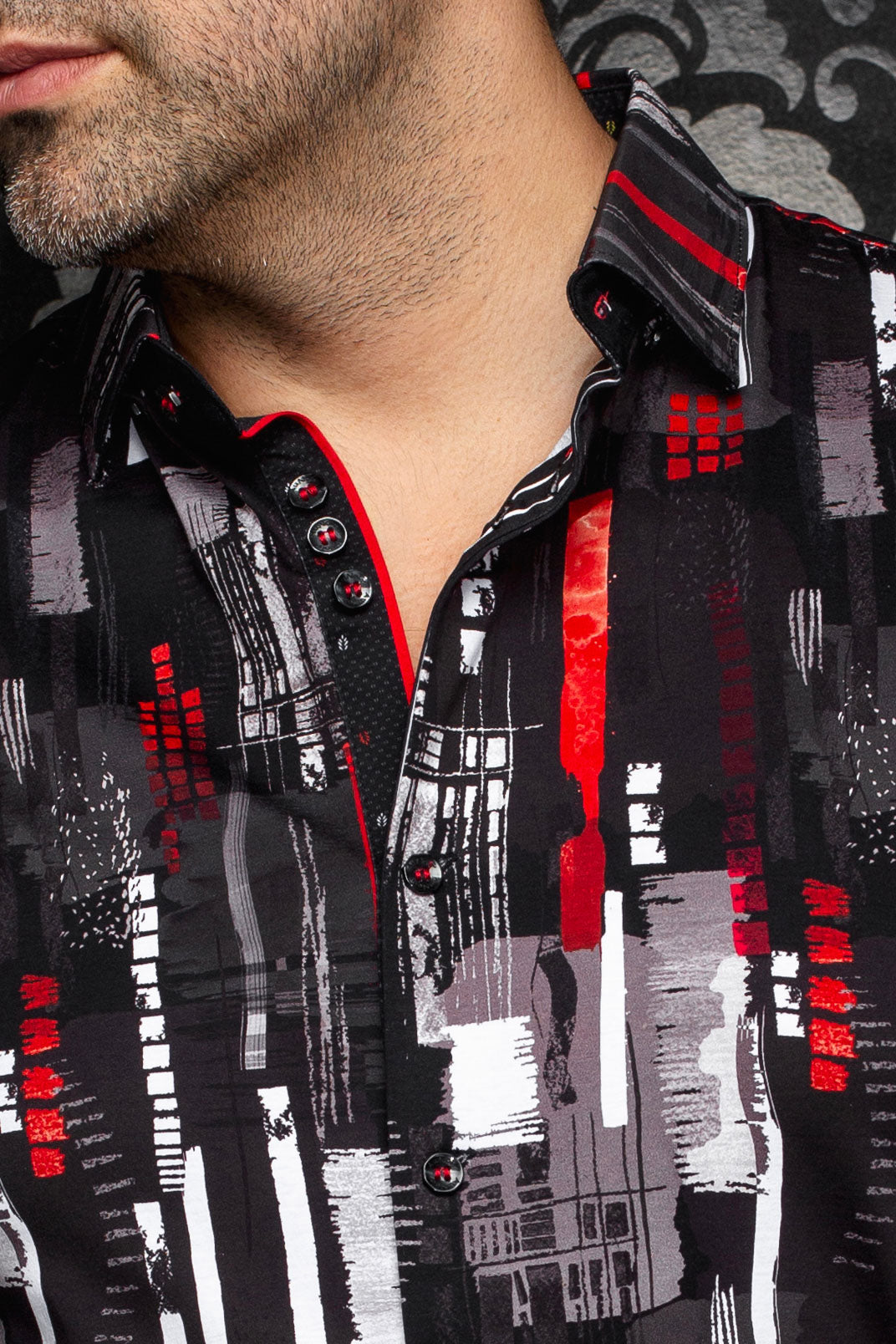 Au Noir men's black printed button-up shirt collar with striped inner collar detail and red piping, close-up
