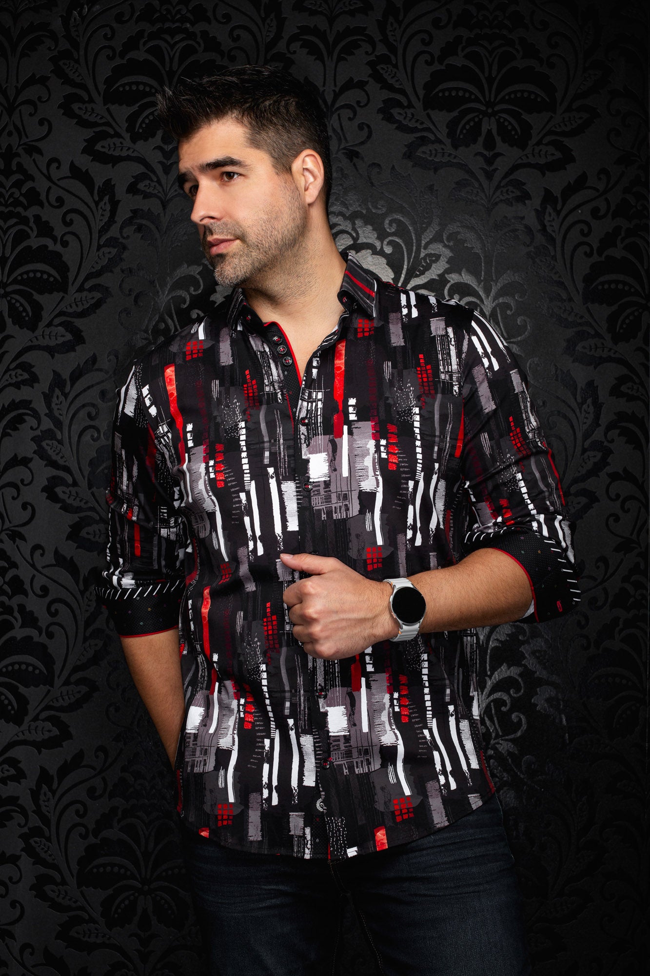Front view of men's black printed button-up shirt with rolled sleeves, curved hem and red accents by Au Noir