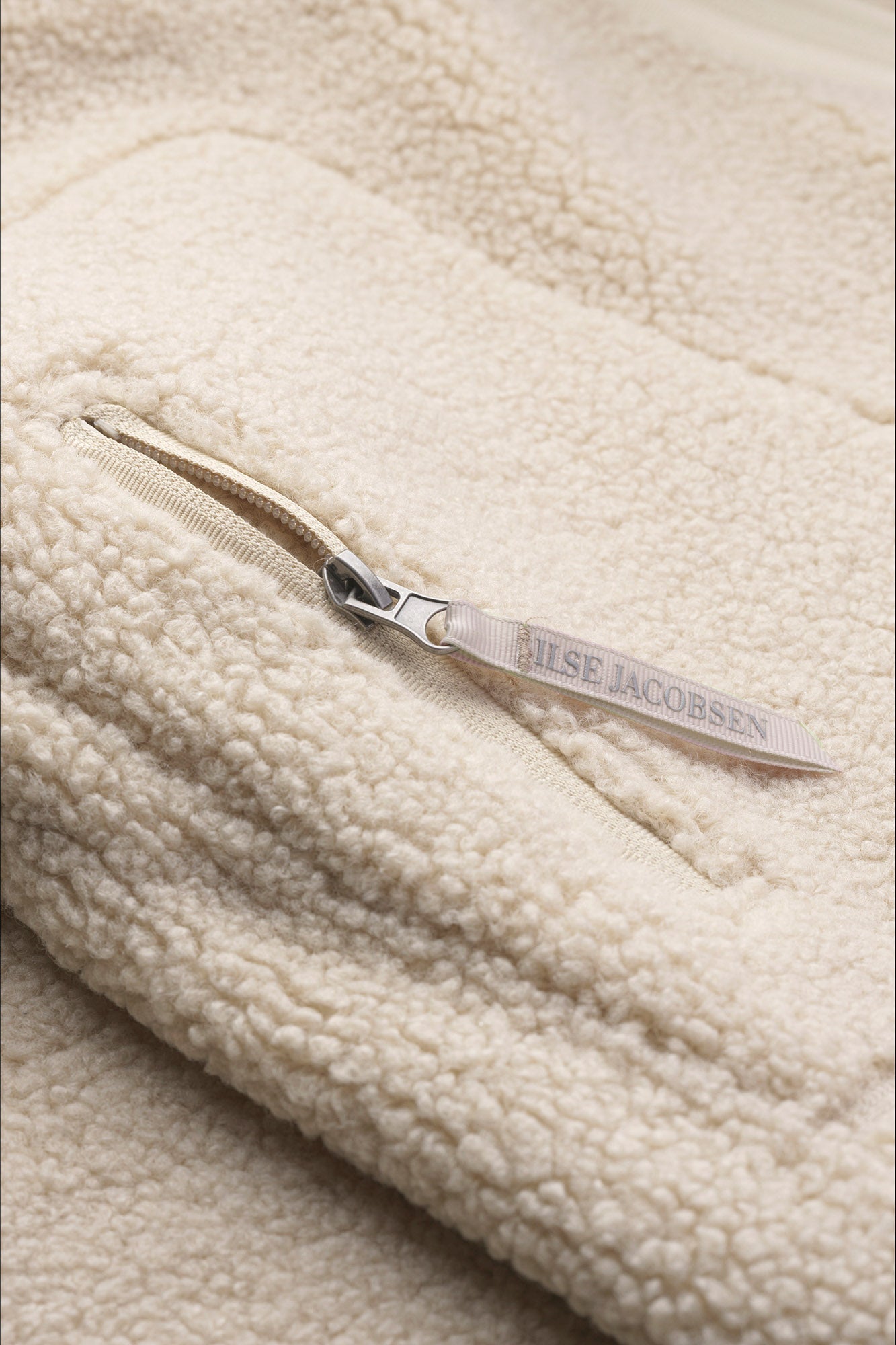 Ilse Jacobsen women's cream teddy fleece jacket zipper with branded pull and plush texture, close-up