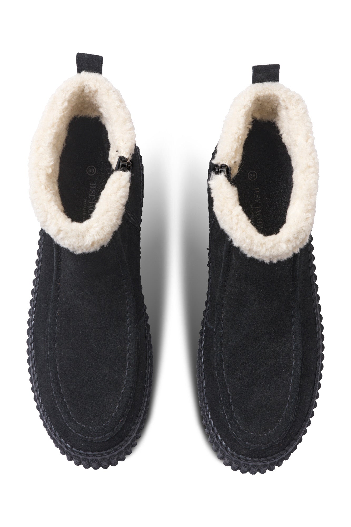 Women's black ankle boots angled front view with cream plush cuff, side zipper, and ribbed sole by Ilse Jacobsen