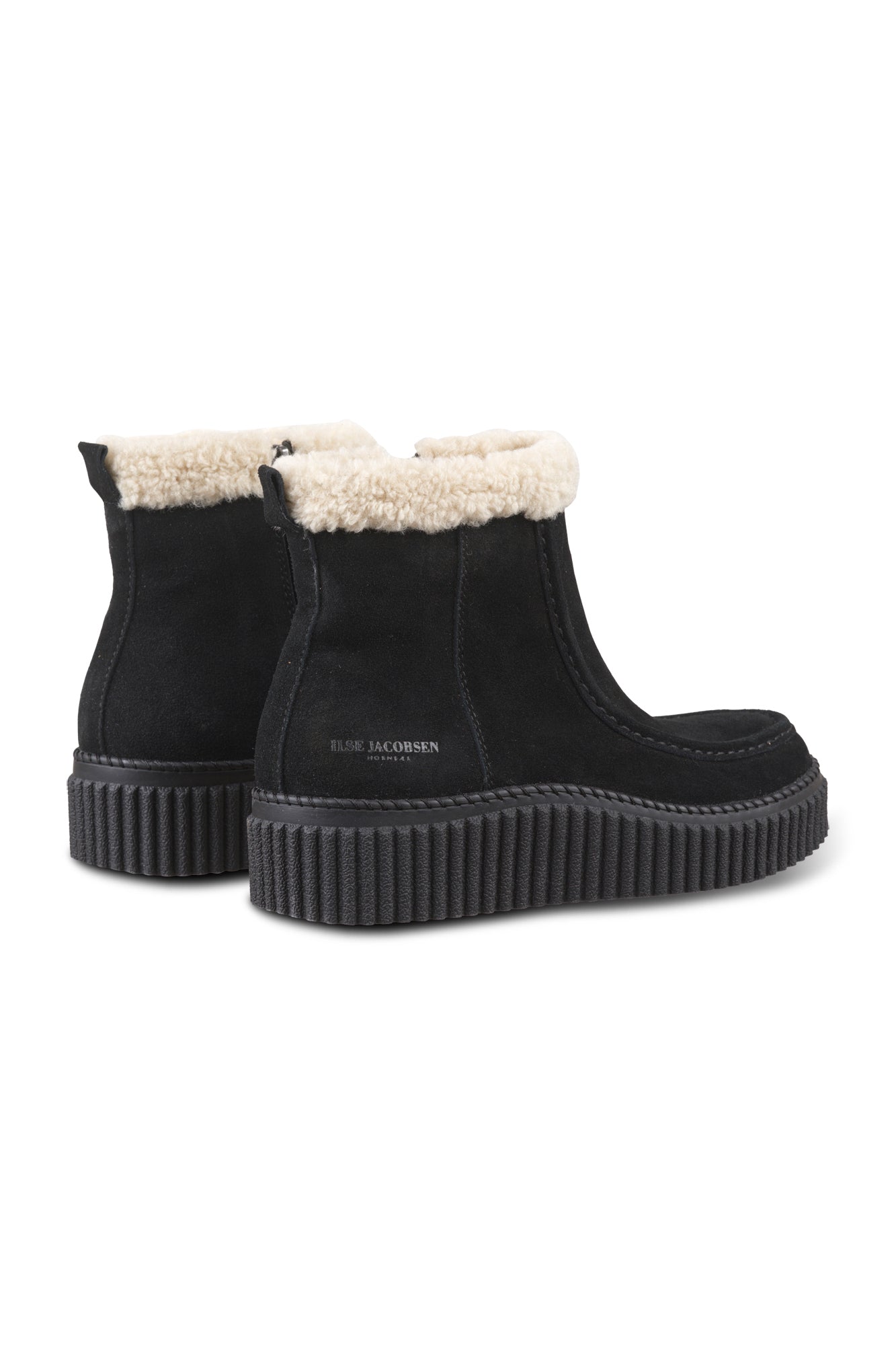 Women's black ankle boots angled front view with cream plush cuff, side zipper, and ribbed sole by Ilse Jacobsen