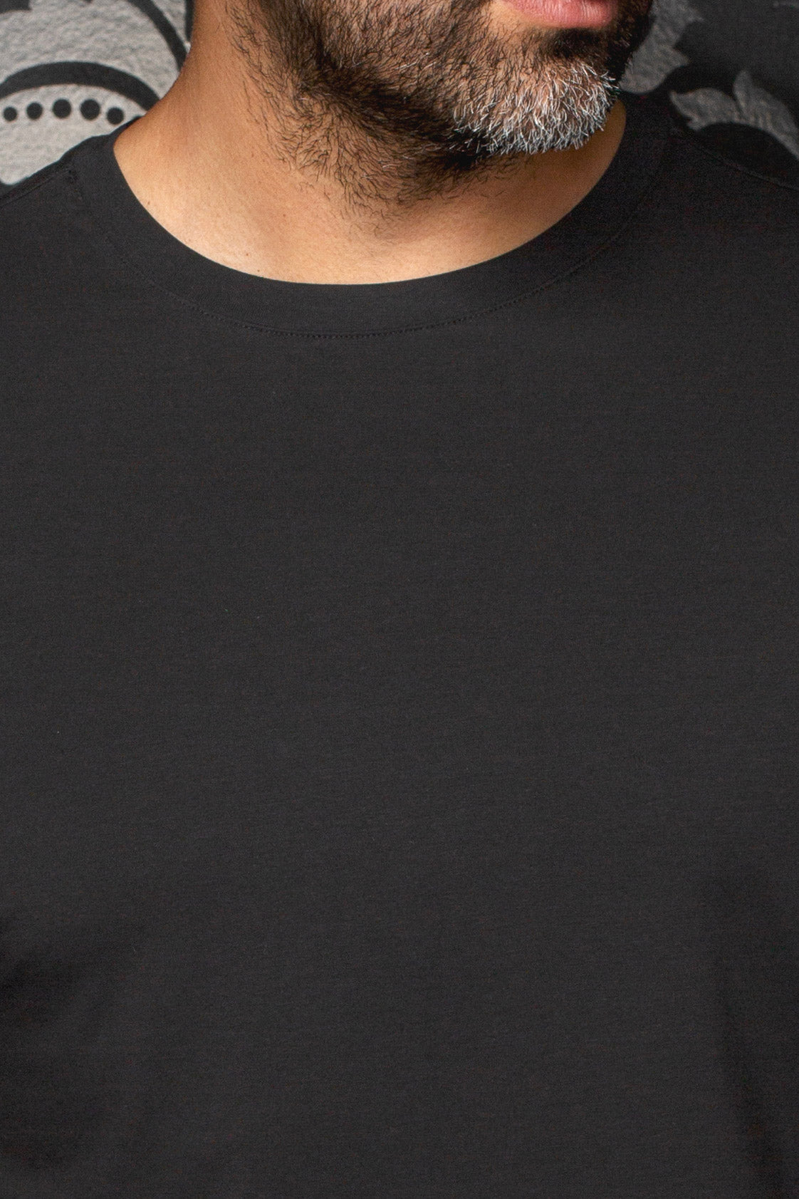 Close-up of neckline stitching and plain jersey surface on Au Noir men's black Short-sleeve T-Shirt crewneck