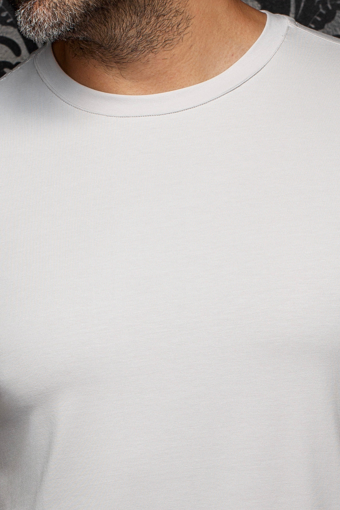 Au Noir men's light gray crewneck Short-sleeve T-Shirt shown close-up with smooth jersey texture and ribbed collar