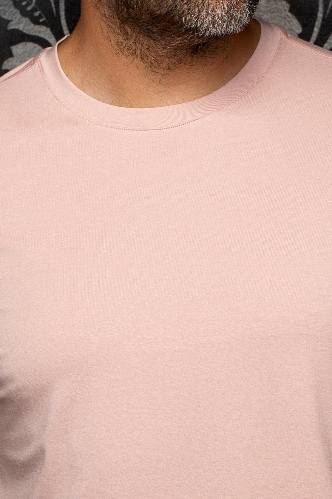Au Noir men's pale pink crewneck Short-sleeve T-Shirt shown close-up with smooth knit surface and ribbed collar