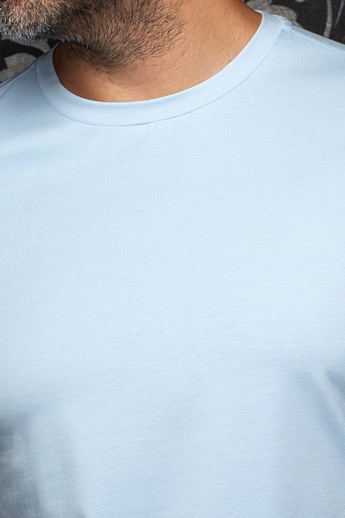 Close-up of men's light blue Short-sleeve T-Shirt crewneck collar and smooth knit fabric by Au Noir