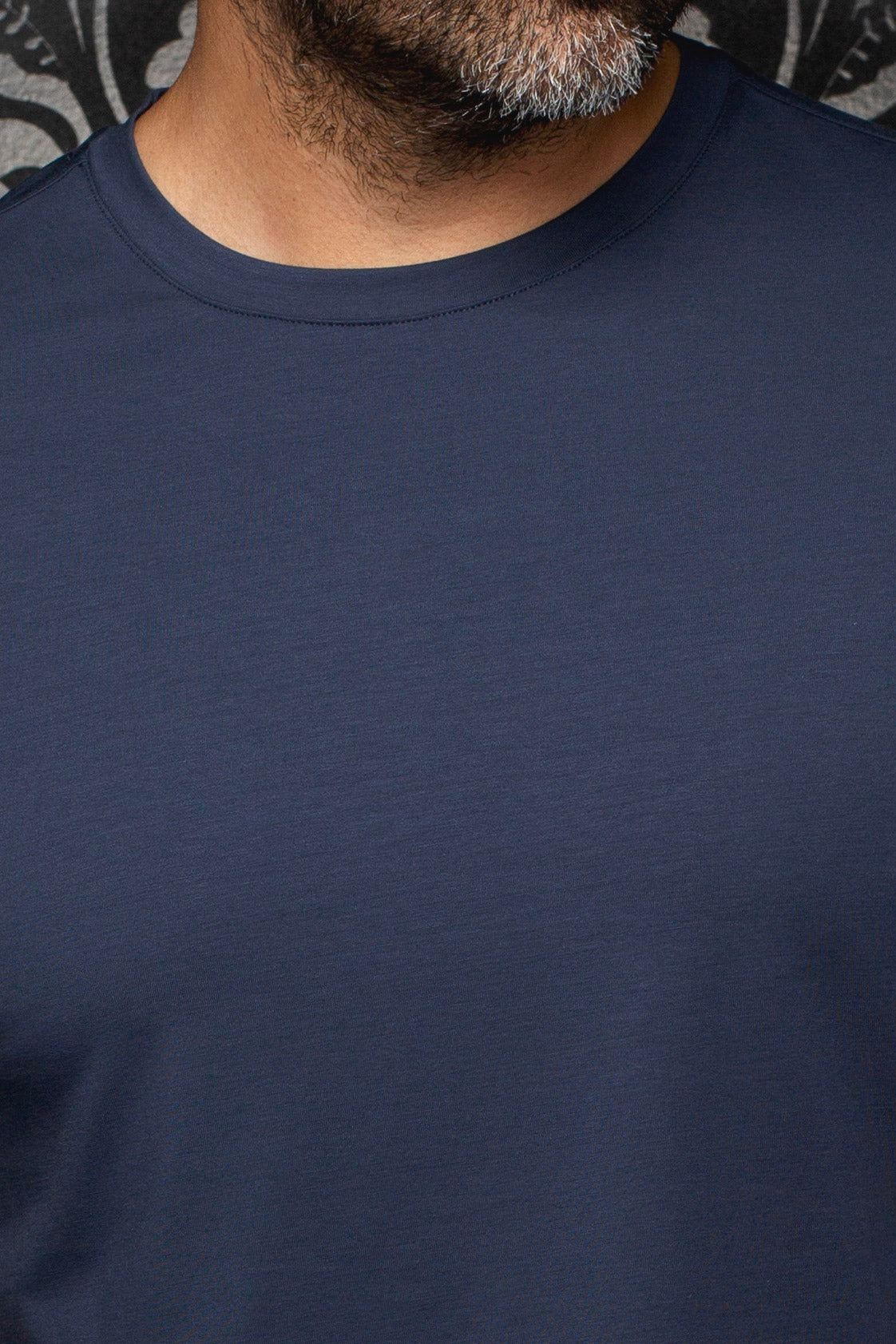 Men's detail of navy Short-sleeve T-Shirt showing solid jersey fabric and ribbed crewneck by Au Noir