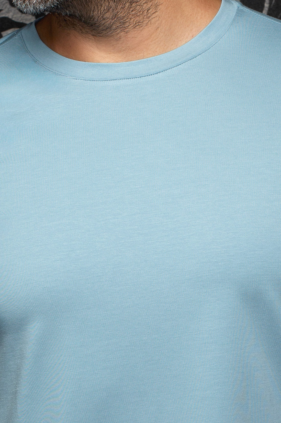 Au Noir men's light blue Short-sleeve T-Shirt shown close-up with smooth jersey texture and ribbed crewneck