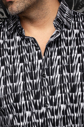 Au Noir men's black and white abstract print shirt shown close-up with black buttons, placket and spread collar