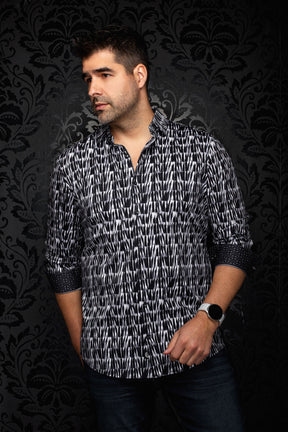 Front model view of men's black and white abstract print button-up shirt with open collar and rolled cuffs by Au Noir