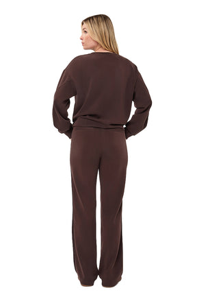 Women's full back view of dark brown relaxed crewneck sweatshirt styled with matching pants by Esqualo