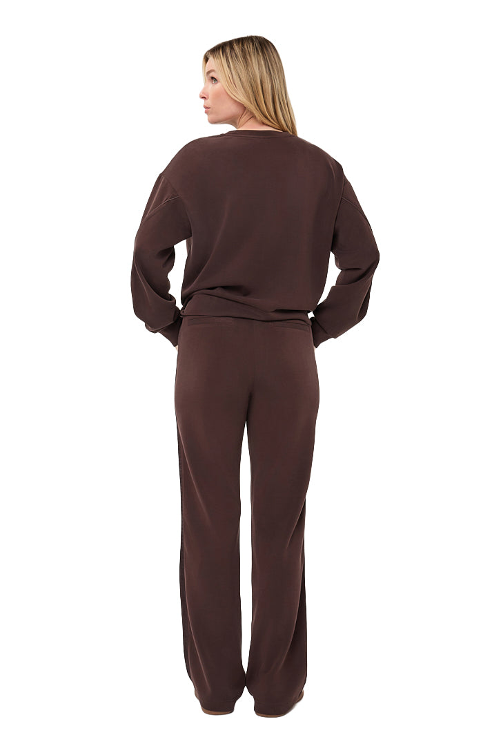 Women's full back view of dark brown relaxed crewneck sweatshirt styled with matching pants by Esqualo