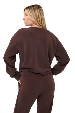 Esqualo women's back waist-up view of dark brown crewneck sweatshirt with dropped shoulders and ribbed hem