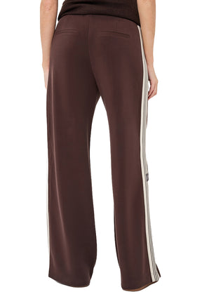 Esqualo women's brown wide-leg pants with welt pockets and cream striped side panels shown from the back