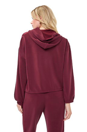 Esqualo women's burgundy hoodie showing attached hood, dropped shoulders, and elastic cuffs, back view