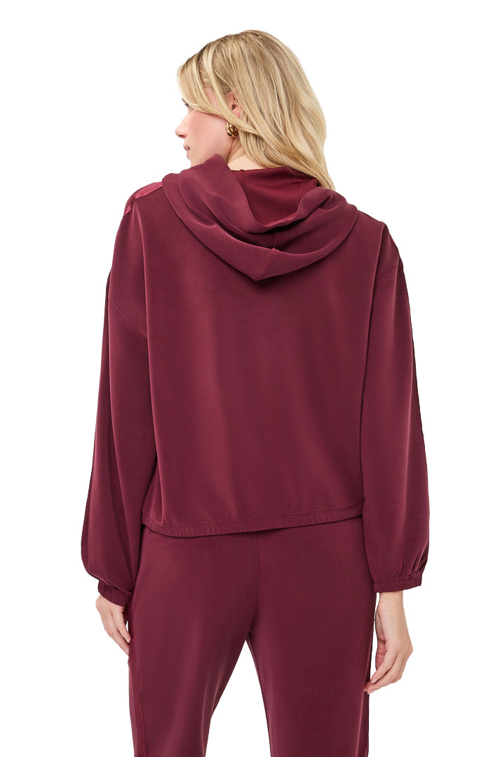 Esqualo women's burgundy hoodie showing attached hood, dropped shoulders, and elastic cuffs, back view