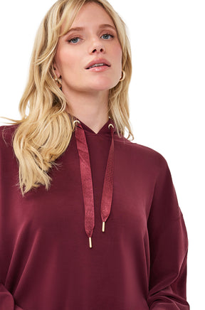 Esqualo women's close front view of burgundy hoodie with hood drawcords, gold-tone tips, and smooth fabric
