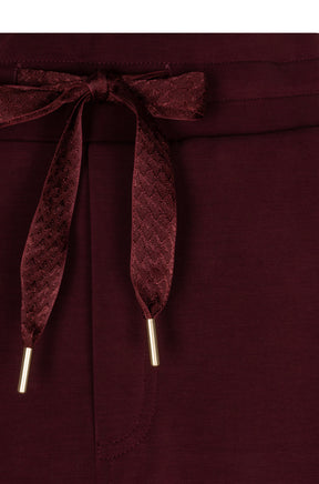Esqualo women's burgundy skirt waistband with patterned drawstring and gold-tone tips, close-up