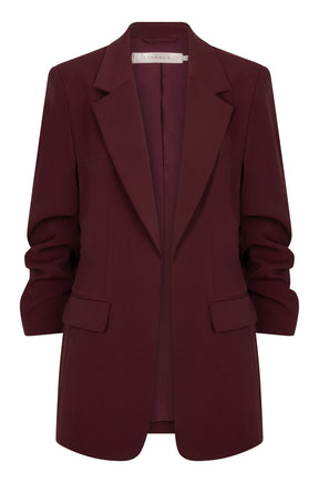 Esqualo women's burgundy blazer with notched lapels, flap pockets and ruched sleeves shown from the front