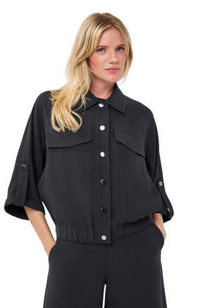 Esqualo women's black cropped blouse with pointed collar, flap pockets, and sleeve tabs shown from the front