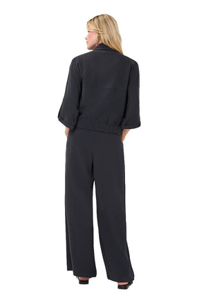 Esqualo women's black cropped blouse with elbow-length sleeves and gathered elastic hem shown from the back