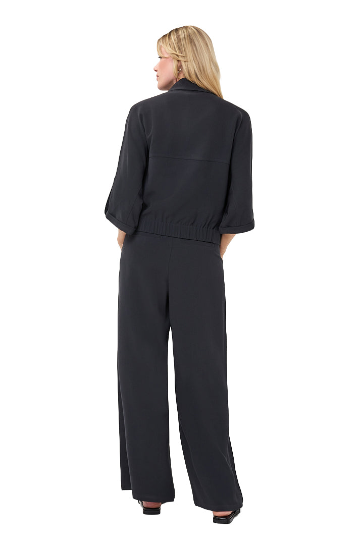 Esqualo women's black cropped blouse with elbow-length sleeves and gathered elastic hem shown from the back