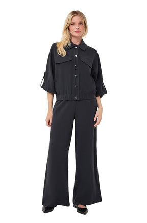 Esqualo women's full front view of black button-front blouse with chest flap pockets and cropped elastic hem