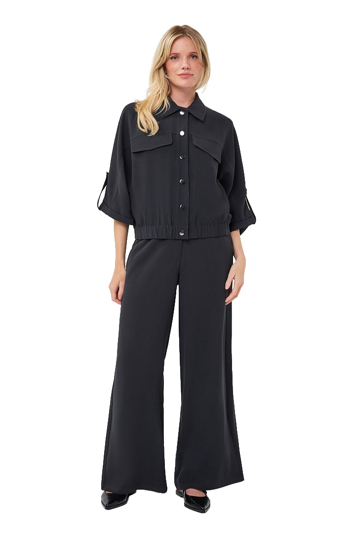 Esqualo women's full front view of black button-front blouse with chest flap pockets and cropped elastic hem