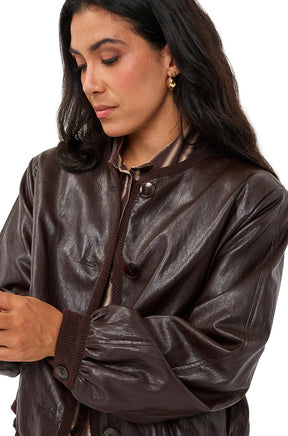 Esqualo women's dark brown shiny jacket with round ribbed neckline, buttons and gathered cuff, close view