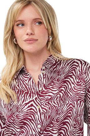 Esqualo women's ivory and burgundy printed long-sleeve blouse showing point collar and light button placket, close-up