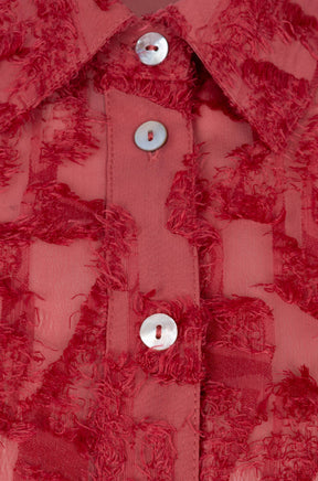Esqualo women's detail of red long-sleeve blouse collar, pearl-like buttons, and raised fringed abstract texture