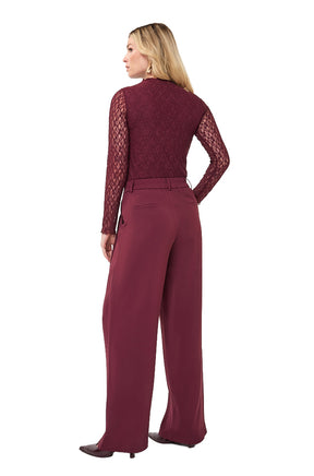 Esqualo women's full back angled view of a burgundy lace mock neck long-sleeve blouse worn tucked into trousers, side view