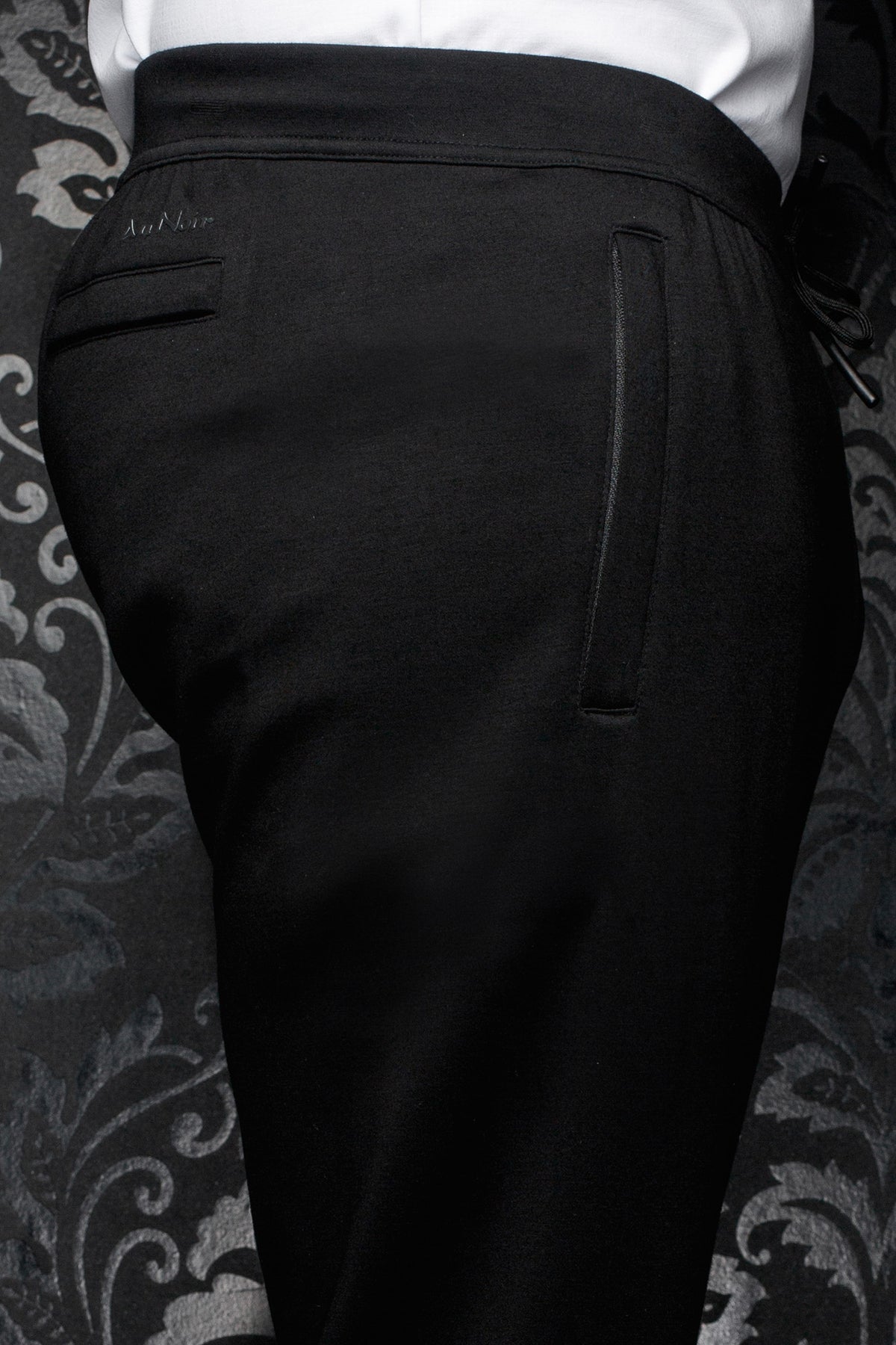 Au Noir men's black jogging pants with tonal logo, back welt pocket and wide waistband, close view