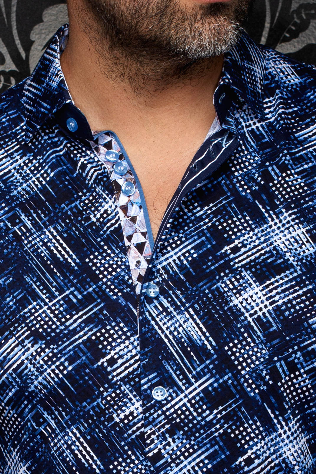 Au Noir men's navy patterned button-up shirt with light blue buttons and open collar, close-up