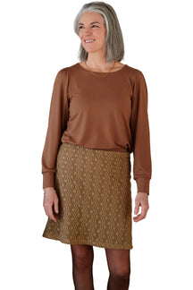 Rien ne se perd, tout se crée women's golden brown knee-length lace skirt, front view on model with openwork floral texture