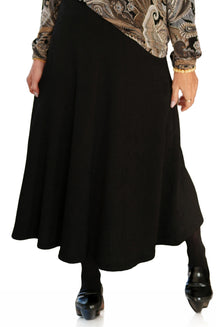 Rien ne se perd, tout se crée women's black flared midi skirt with vertical texture and a wide hem shown from the front