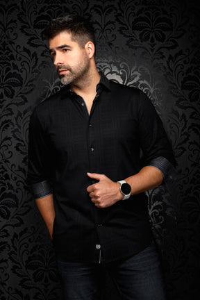 Men's angled model view of a black button-up shirt with rolled contrast cuffs and tonal grid texture, side view by Au Noir