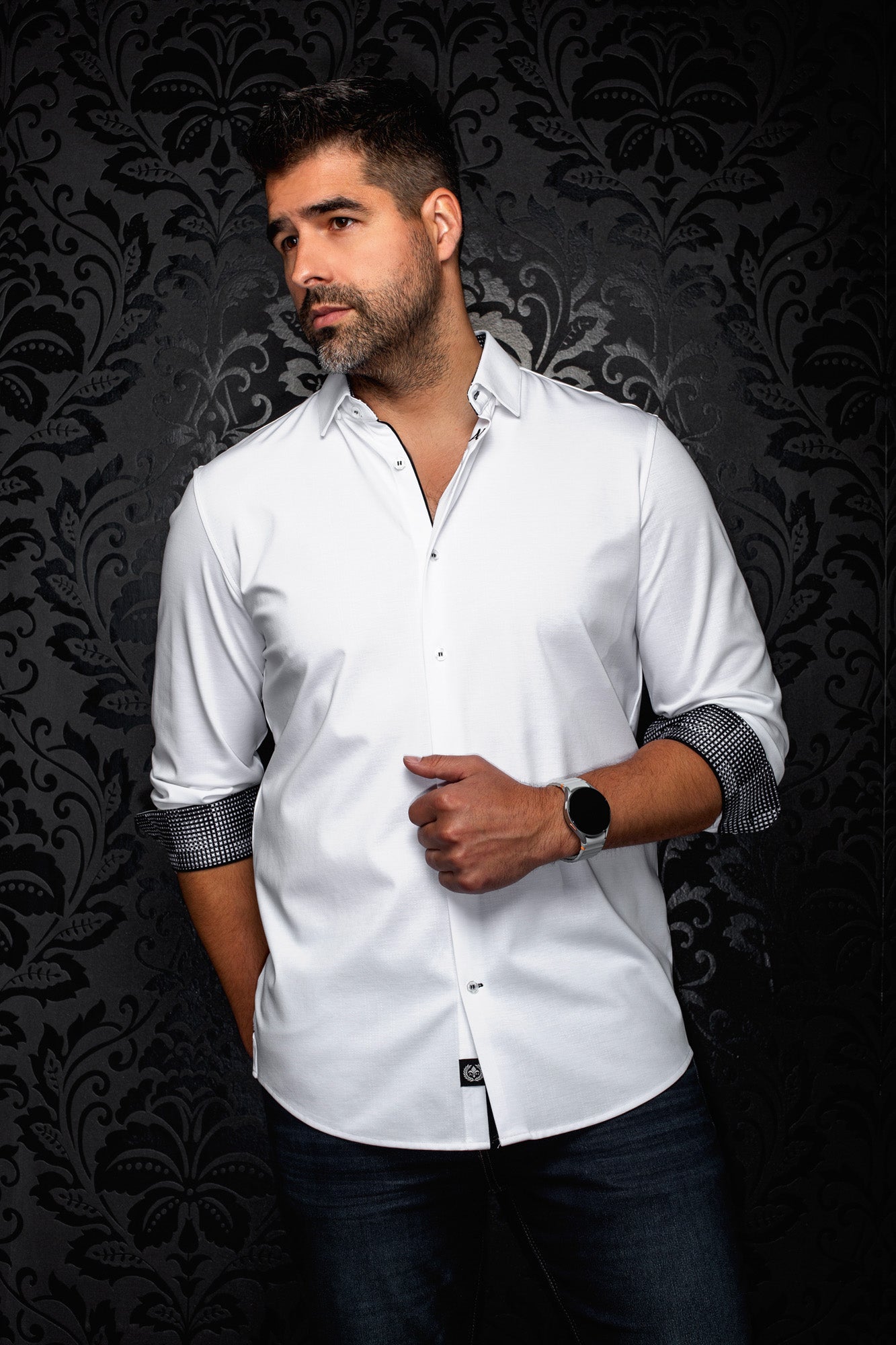 Au Noir men's white long sleeve button-up shirt, front angled view with black trim and rolled patterned cuffs, side view