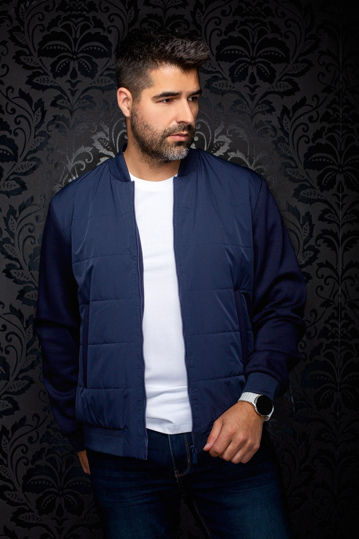 Sur mannequin de face, le coupe-vent mi-saison style bomber bomber matelassé bleu marine porté ouvert pour homme par Au Noir