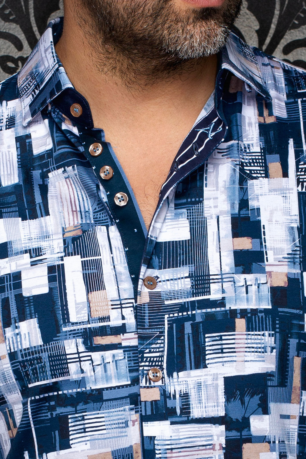Au Noir men's navy printed button-up shirt shown close-up with geometric print, tan buttons, placket and collar
