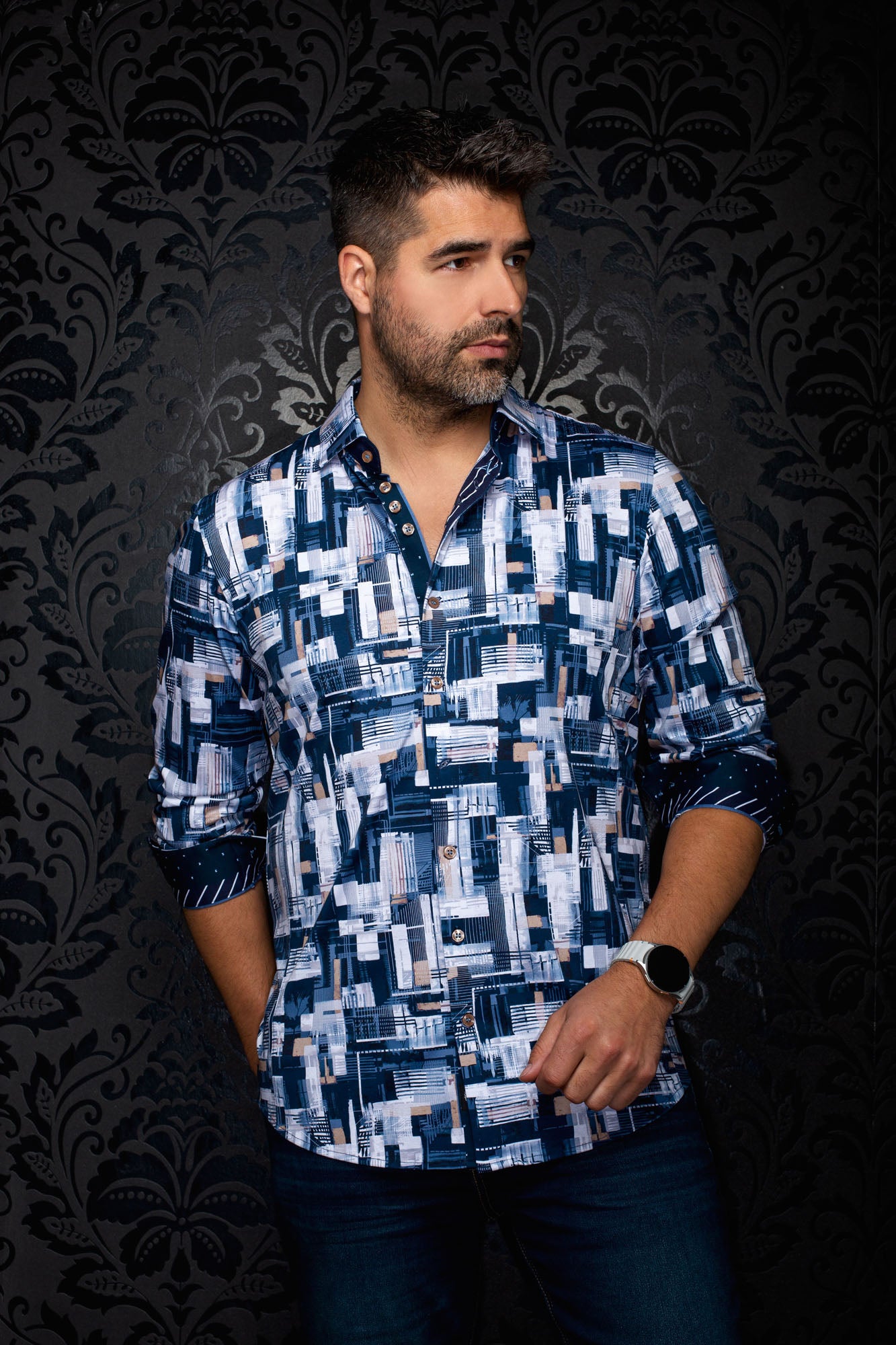Men's navy geometric-print button-up shirt on model with contrast cuff facing visible and rolled cuffs, side view by Au Noir