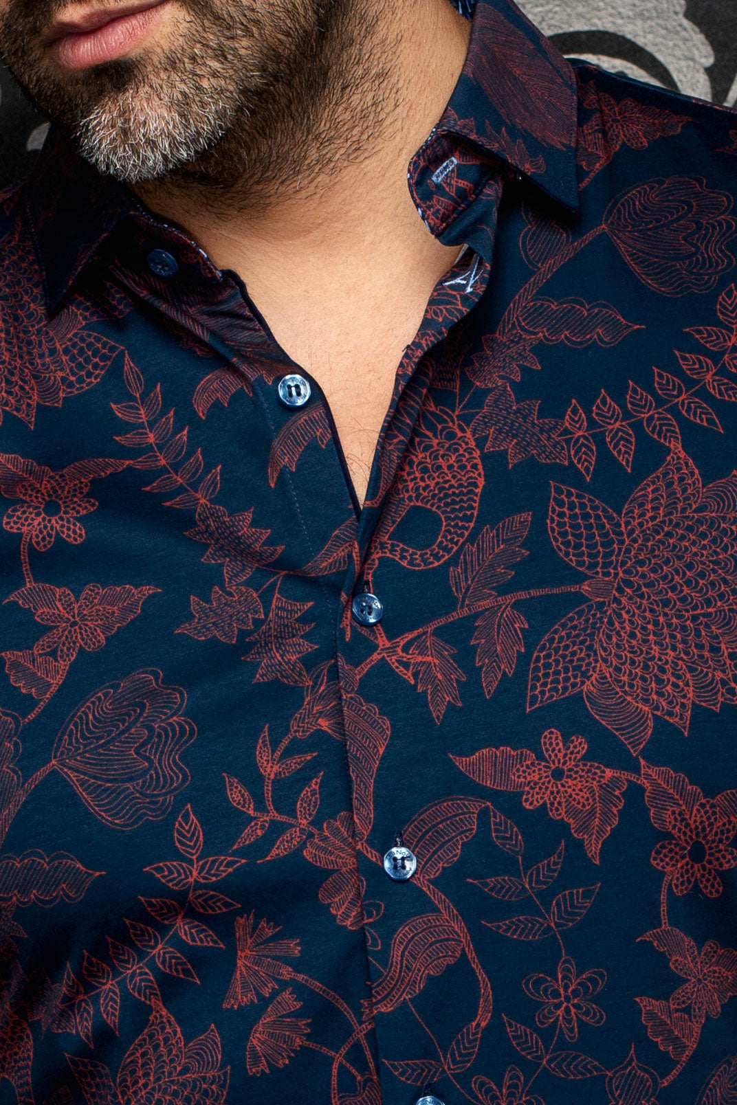 Au Noir men's navy floral button-up shirt shown close-up with burgundy print, blue buttons and spread collar