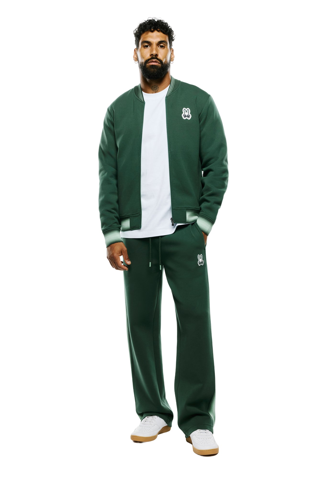 Psycho Bunny men's dark green wide-leg sweatpants with drawstring waist and thigh logo patch, front full-body view