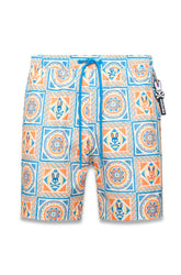 Psycho Bunny men's cream swim shorts with blue drawstring and orange-blue tiled skull-bunny print, front view